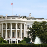 White House exterior featuring American flag, fountain, and classic columns&mdash;highlighting U.S. plumbing history.