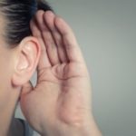 Close-up of a person's ear as they listen, representing attentive customers for B & D Plumbing and air conditioning guidance.