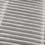 Air filter with a layered, patterned structure in light gray, emphasizing air quality and cleanliness for HVAC systems.
