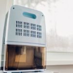 Modern dehumidifier by B & D Plumbing, Heating & A/C positioned near window, enhancing indoor air quality and comfort.