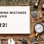 Signboard reading "PLUMBING MISTAKES TO AVOID 2022!" with organized plumbing tools on a wood background for B & D Plumbing.