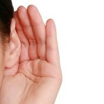 Human hand cupping ear, highlighting attentive listening during heater maintenance, B & D Plumbing, Heating & A/C.