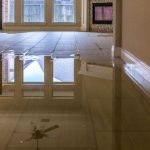 Home interior with flooded floor, revealing water damage. B & D Plumbing, Heating & A/C offers repair solutions.